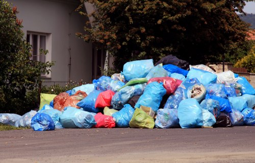 Workers and a collection vehicle at a commercial waste site