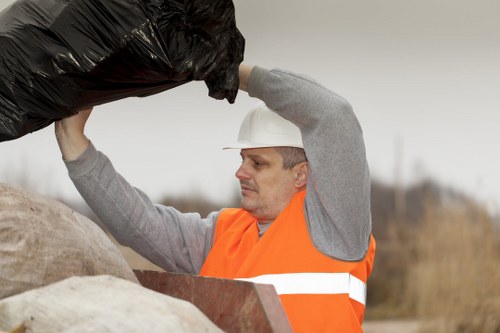 Crew member assisting a business customer with waste container placement on site